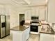 Bright kitchen with white cabinets, an island, stainless steel appliances, and a combo oven at 3648 Sleepy Hollow, Wake Forest, NC 27587