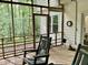 Relaxing screened porch featuring rocking chairs and view of the wooded backyard at 3648 Sleepy Hollow, Wake Forest, NC 27587