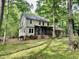 Back exterior showcases a screened in porch, yard space, and natural surrounding scenery at 3648 Sleepy Hollow, Wake Forest, NC 27587