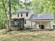 Rear exterior features a screened porch and yard area surrounded by the beauty of nature at 3648 Sleepy Hollow, Wake Forest, NC 27587