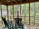 Relax on the screened porch with comfortable seating and enjoy the views of the surrounding trees at 3648 Sleepy Hollow, Wake Forest, NC 27587