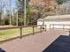 Backyard boasts a large deck and storage building with nature as the backdrop at 3818 Hillgrand Dr, Durham, NC 27705