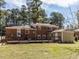 The backyard features a deck and storage building, perfect for outdoor activities and storage at 3818 Hillgrand Dr, Durham, NC 27705
