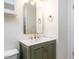 Stylish bathroom featuring a sink with an ornate mirror and gold fixtures at 3818 Hillgrand Dr, Durham, NC 27705