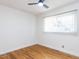 Bright bedroom with hardwood floors, ceiling fan, and double hung window at 3818 Hillgrand Dr, Durham, NC 27705