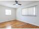 Bright bedroom with hardwood floors, ceiling fan, and double hung window at 3818 Hillgrand Dr, Durham, NC 27705