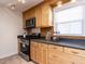 Well-equipped kitchen with wooden cabinets, stainless steel appliances, and ample counter space at 3818 Hillgrand Dr, Durham, NC 27705