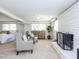 Living room features plush chairs, stylish decor, and a cozy fireplace with a brick surround at 3818 Hillgrand Dr, Durham, NC 27705