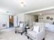 Living room boasts two stylish chairs, neutral carpet, and ample space for relaxation at 3818 Hillgrand Dr, Durham, NC 27705
