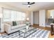 Inviting living room with hardwood floors, a ceiling fan, and large windows for ample sunlight at 3818 Hillgrand Dr, Durham, NC 27705