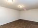 Room with wood look flooring, bright lights and white walls offer a minimalist aesthetic at 3818 Hillgrand Dr, Durham, NC 27705
