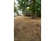 Large backyard with treed border and wooden deck at 408 E Maynard Ave, Durham, NC 27704