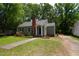 Charming one-story home featuring a brick chimney, walkway, and well-manicured lawn at 408 E Maynard Ave, Durham, NC 27704