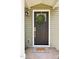 A welcoming front door with wreath, stylish light fixture, and 'HOME' doormat at 408 E Maynard Ave, Durham, NC 27704