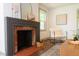 Beautiful fireplace with brick surround with decor in a well-lit living room at 408 E Maynard Ave, Durham, NC 27704