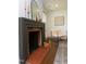 Living room featuring a stylish fireplace, neutral chair, and hardwood flooring at 408 E Maynard Ave, Durham, NC 27704