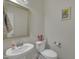Powder room with pedestal sink, mirror, and a decorative art piece at 4137 Lofty Ridge Pl, Morrisville, NC 27560