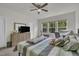 Bright bedroom featuring a ceiling fan, neutral walls, and multiple windows letting in natural light at 4137 Lofty Ridge Pl, Morrisville, NC 27560