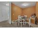 Flex room is staged as a dining room, with a round dining table, four chairs, and an orange wall at 4137 Lofty Ridge Pl, Morrisville, NC 27560