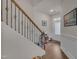 Elegant foyer featuring hardwood floors, a staircase with iron railing, and a white front door at 4137 Lofty Ridge Pl, Morrisville, NC 27560