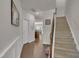 Bright foyer with hardwood floors, stairs, and white wainscoting leading to a welcoming home at 4137 Lofty Ridge Pl, Morrisville, NC 27560