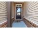 Inviting front door framed by a brick facade and beige siding, complete with a welcoming mat at 4137 Lofty Ridge Pl, Morrisville, NC 27560