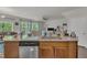 Open concept kitchen with island and stainless steel dishwasher overlooking dining and living spaces at 4137 Lofty Ridge Pl, Morrisville, NC 27560