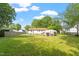 A large backyard features expansive greenery, mature trees and room for outdoor activities at 414 N Cypress St, Wendell, NC 27591