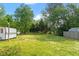 A large backyard features expansive greenery, mature trees and room for outdoor activities at 414 N Cypress St, Wendell, NC 27591