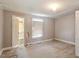 Empty bedroom with a large window letting in natural light at 414 N Cypress St, Wendell, NC 27591