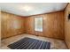 Carpeted bedroom with wood-paneled walls and a single window at 414 N Cypress St, Wendell, NC 27591