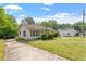 Classic single-story home with a large front yard and established shrubs, presenting a picture of suburban tranquility at 414 N Cypress St, Wendell, NC 27591