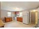Kitchen view with wooden cabinets, white appliances, and double windows at 414 N Cypress St, Wendell, NC 27591