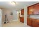 Alternate view of kitchen with wooden cabinets, double windows, and overhead lighting at 414 N Cypress St, Wendell, NC 27591