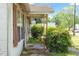 Close-up of a charming covered porch with decorative columns and lush greenery, enhancing its inviting appeal at 414 N Cypress St, Wendell, NC 27591