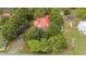 Aerial view of wooded property featuring a home with a red roof at 429 N Asheboro St, Liberty, NC 27298