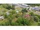 Aerial view of wooded property with houses, commercial areas and train tracks nearby at 429 N Asheboro St, Liberty, NC 27298