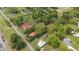 Aerial view displaying houses and land surrounded by mature trees in the neighborhood at 429 N Asheboro St, Liberty, NC 27298