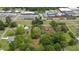Aerial shot of a wooded property with houses and commercial areas nearby at 429 N Asheboro St, Liberty, NC 27298
