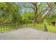 View from a back deck featuring a green, wooded area with a shed at 429 N Asheboro St, Liberty, NC 27298