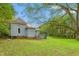 Backyard view featuring a home, steps to deck and a grassy yard with scattered leaves at 429 N Asheboro St, Liberty, NC 27298