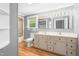Updated bathroom with double sinks, vanity, and shower-tub combo at 429 N Asheboro St, Liberty, NC 27298