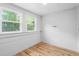 Bright bedroom featuring wood floors, two windows and white walls at 429 N Asheboro St, Liberty, NC 27298