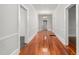 Spacious hallway featuring beautiful hardwood floors and access to multiple rooms at 429 N Asheboro St, Liberty, NC 27298