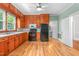 Traditional kitchen with knotty pine cabinets, black appliances, and a view to the backyard at 429 N Asheboro St, Liberty, NC 27298