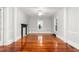 Spacious living room featuring gleaming hardwood floors, fireplace, and white trim at 429 N Asheboro St, Liberty, NC 27298