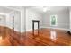 Spacious living room with hardwood floors, white walls, and black fireplace at 429 N Asheboro St, Liberty, NC 27298