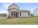 Charming back exterior with a covered patio, offers a perfect blend of indoor-outdoor living at 4405 Aubaun Way, Knightdale, NC 27545