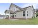 Stunning back exterior featuring a covered patio with outdoor seating, showcasing the perfect space for relaxation and entertaining at 4405 Aubaun Way, Knightdale, NC 27545