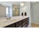 Bathroom featuring a double sink vanity with dark wood cabinets and framed mirrors at 4405 Aubaun Way, Knightdale, NC 27545